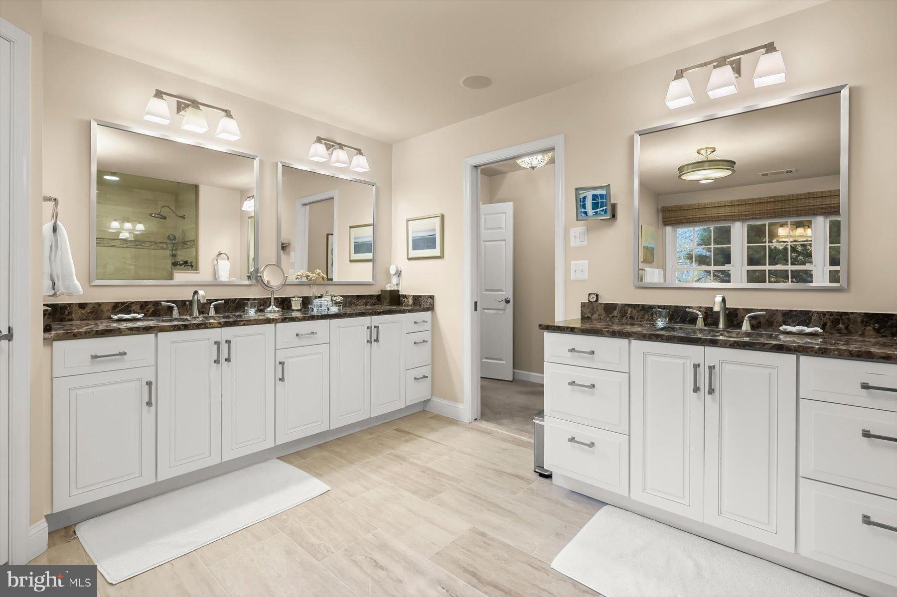 7828 Stable Way Potomac, MD 20854 - Photo 34 of 60 a spacious bathroom with a granite countertop sink mirror and double