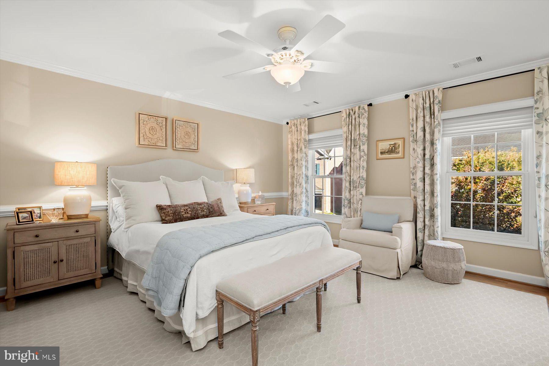 7828 Stable Way Potomac, MD 20854 - Photo 40 of 60 a spacious bedroom with a bed a couch and a chandelier