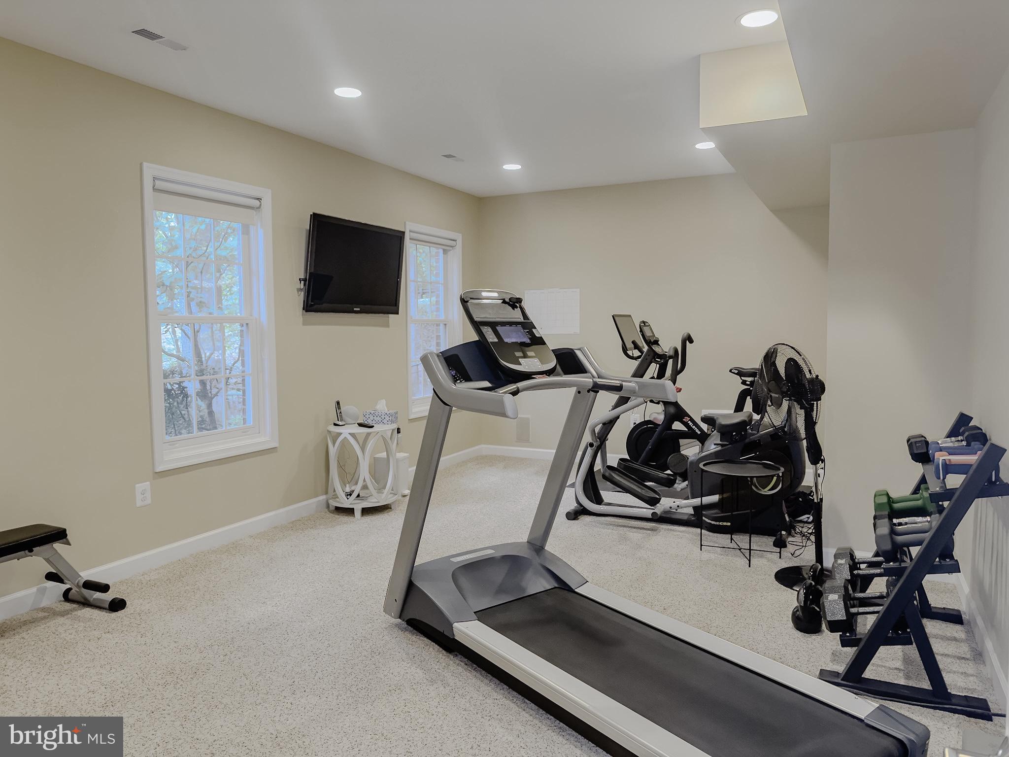 7828 Stable Way Potomac, MD 20854 - Photo 52 of 60 a room with gym equipment and a flat screen tv