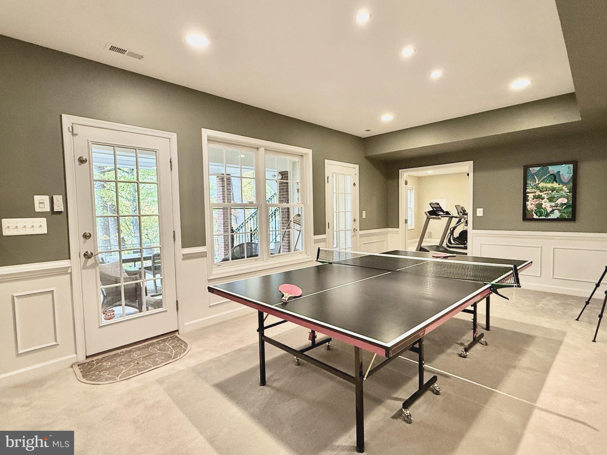 7828 Stable Way Potomac, MD 20854 - Photo 55 of 60 a living room with furniture a table and large windows