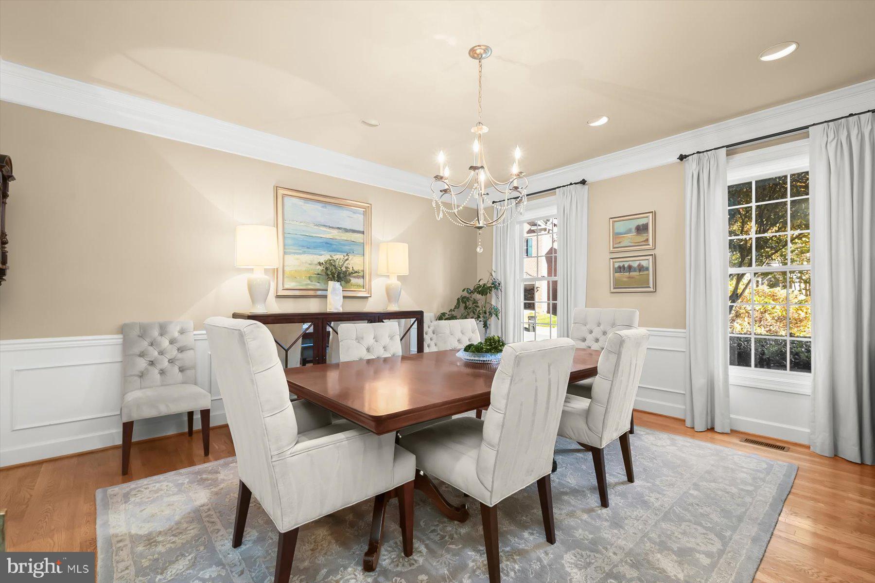 7828 Stable Way Potomac, MD 20854 - Photo 6 of 60 a dining room with furniture a chandelier and wooden floor