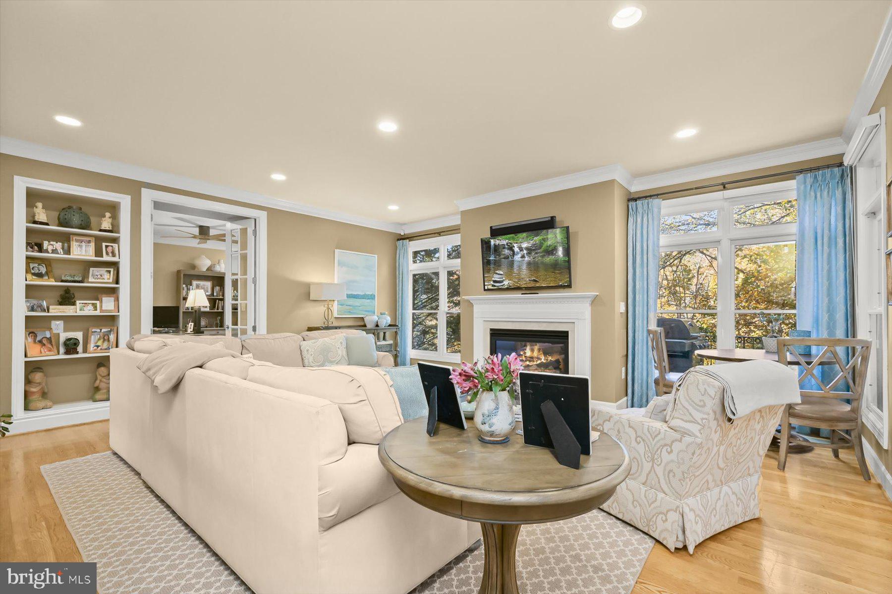 7828 Stable Way Potomac, MD 20854 - Photo 8 of 60 a living room with fireplace furniture and a large window