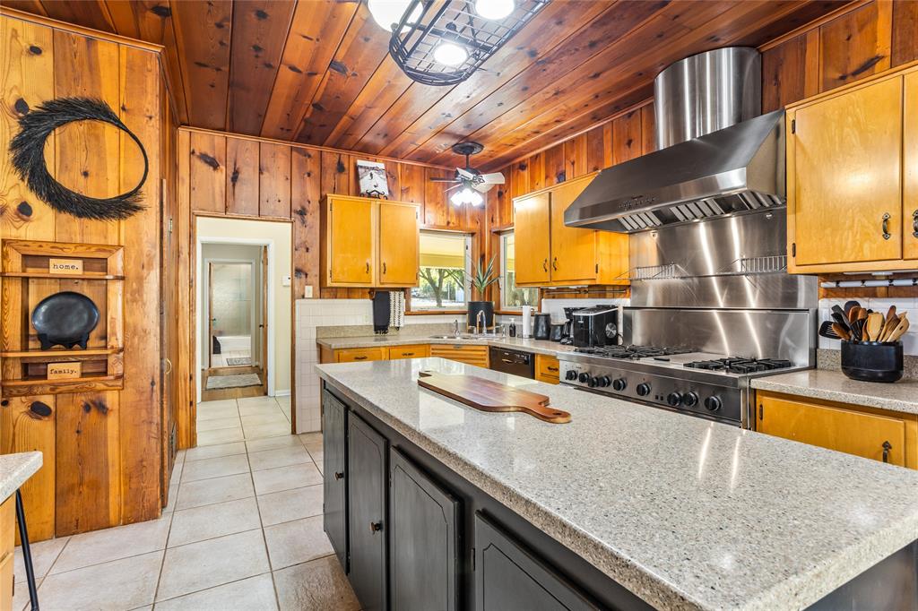 916 Kimbrough Road Azle, TX 76020 - Photo 14 of 40 a kitchen with stainless steel appliances granite countertop a sink a stove and a wooden cabinets