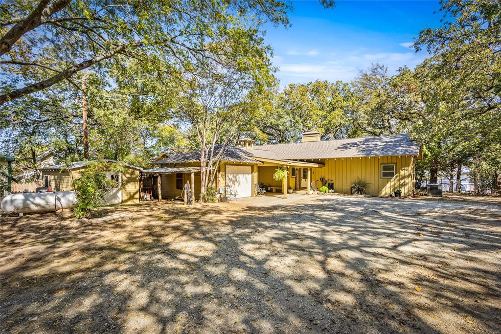 916 Kimbrough Road Azle, TX 76020 - Photo 2 of 40 a front view of a house with a garden