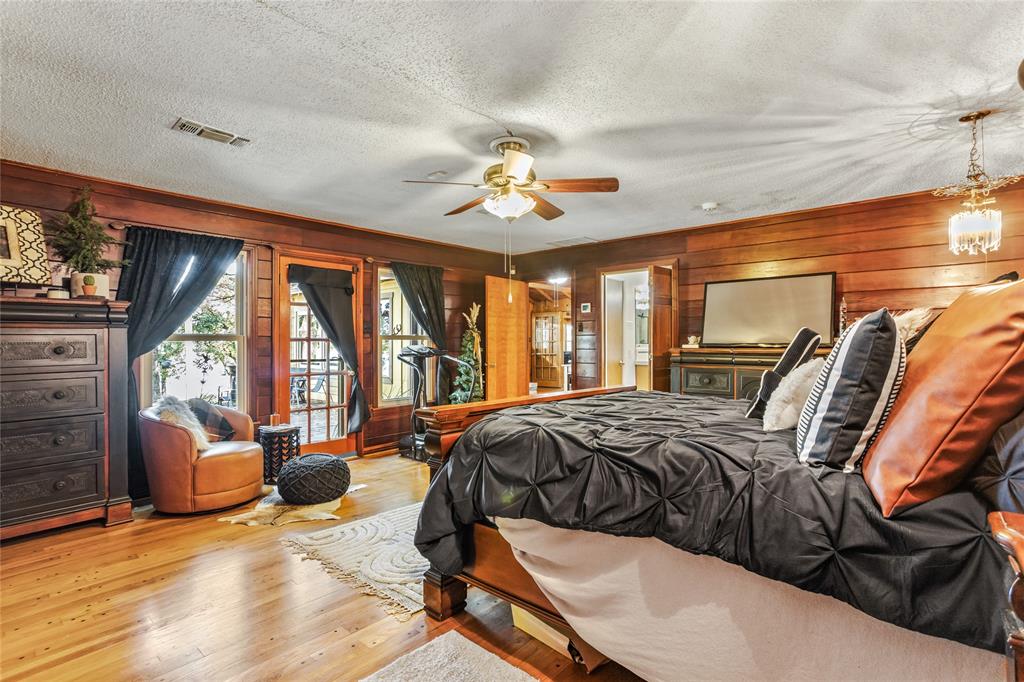 916 Kimbrough Road Azle, TX 76020 - Photo 28 of 40 a spacious bedroom with a bed and glass walk in closet