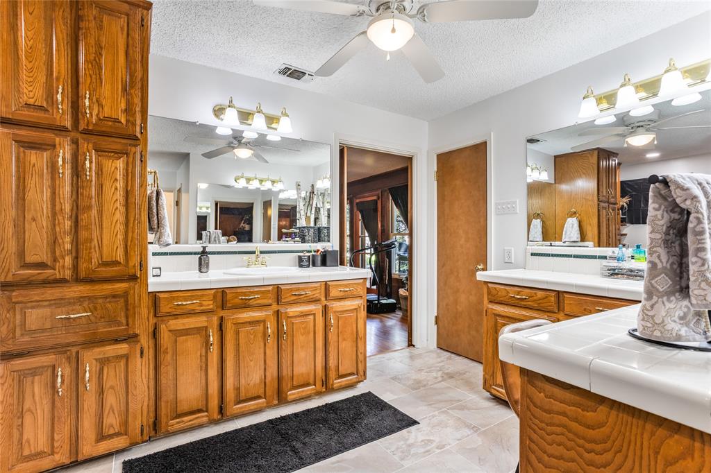 916 Kimbrough Road Azle, TX 76020 - Photo 32 of 40 a spacious bathroom with a sink vanity and mirror