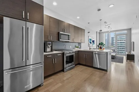 a kitchen with stainless steel appliances a refrigerator sink and microwave