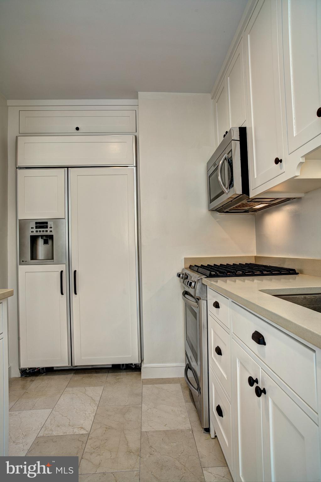 1723 Oakcrest Drive Alexandria, VA 22302 - Photo 17 of 17 a kitchen with cabinets and a stove top oven