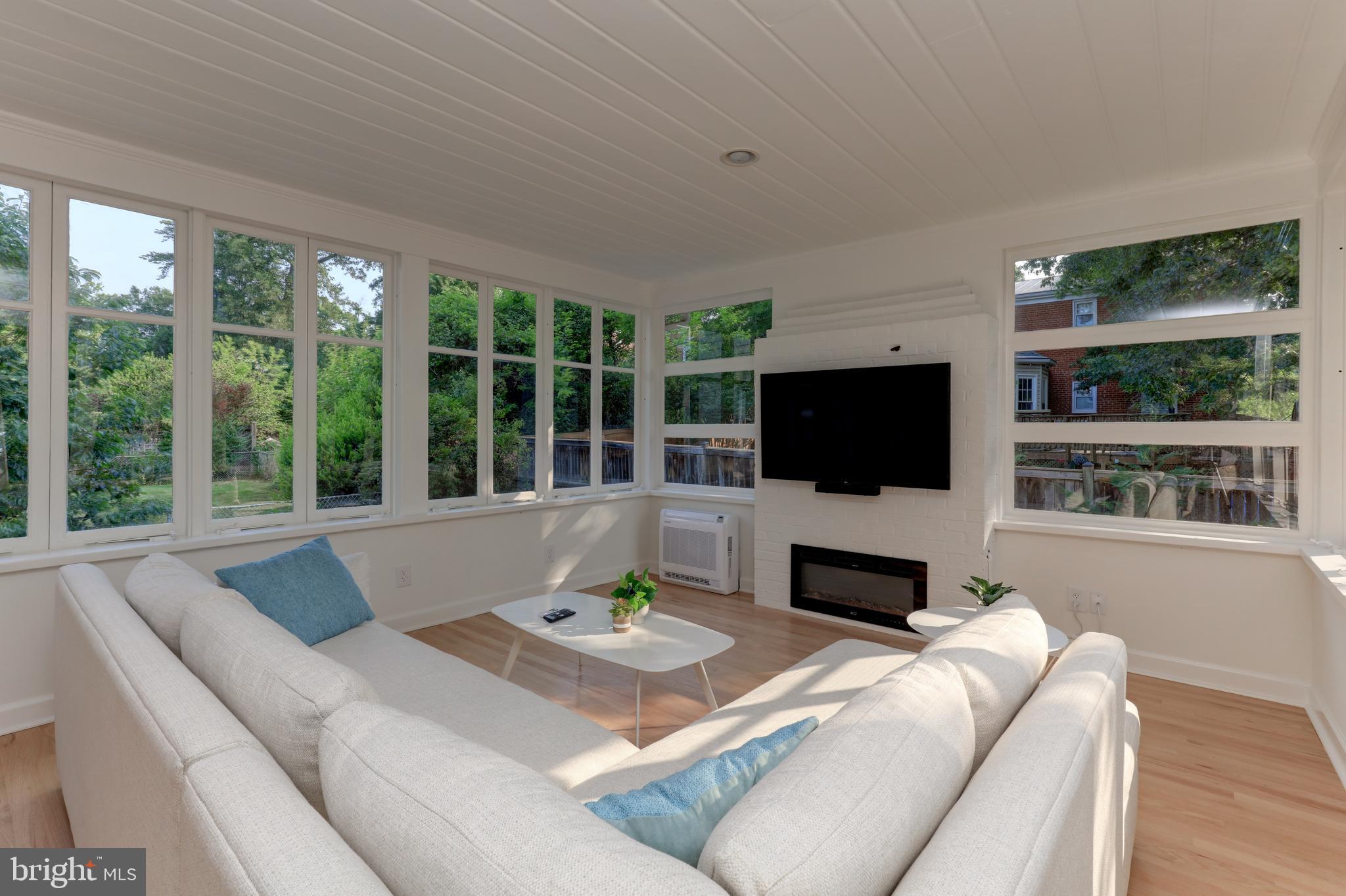 1723 Oakcrest Drive Alexandria, VA 22302 - Photo 3 of 17 a living room with furniture a flat screen tv and a large window