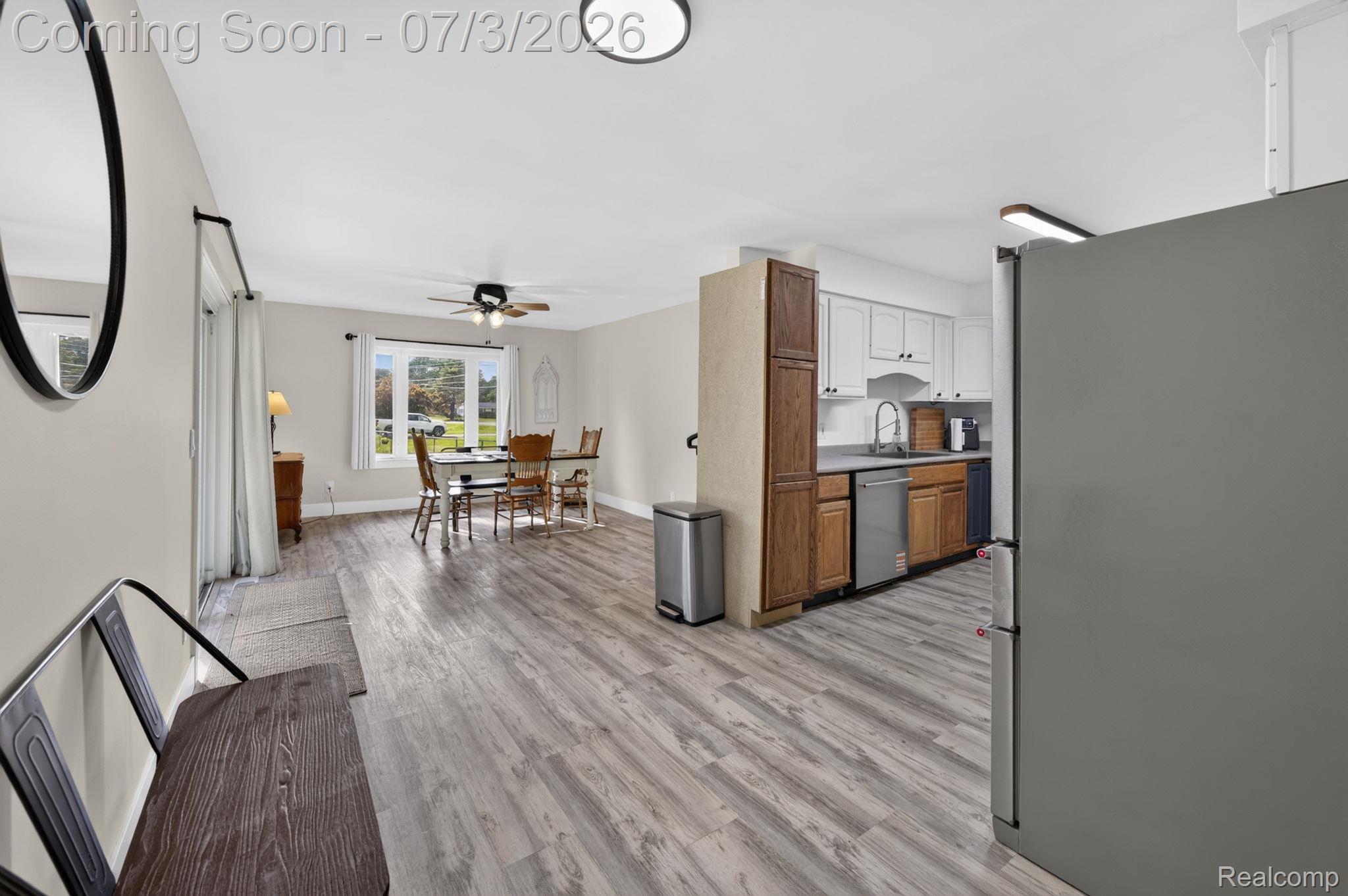 5355 North Seymour Road Flushing, MI 48433 - Photo 9 of 41 Open-concept interior featuring wood-finish flooring, recessed lighting, a ceiling fan, a kitchen with two-tone cabinetry, and stainless steel appliances