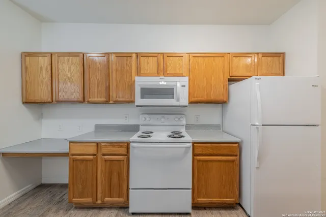a white refrigerator freezer sitting inside of a kitchen