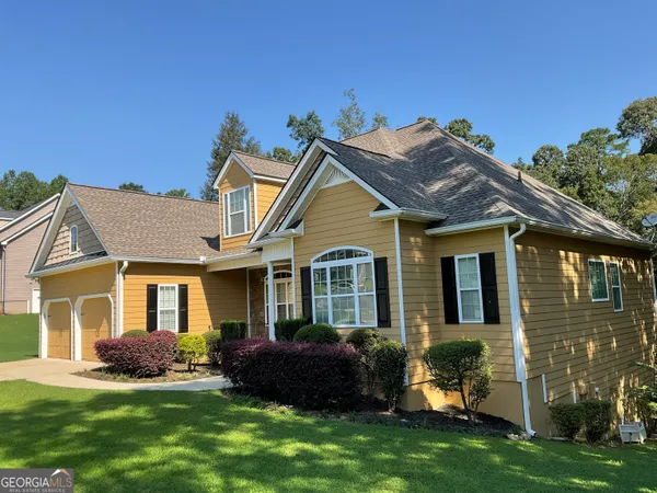 a front view of a house with a garden