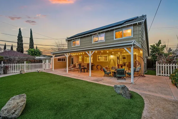 a view of a house with backyard porch and sitting area