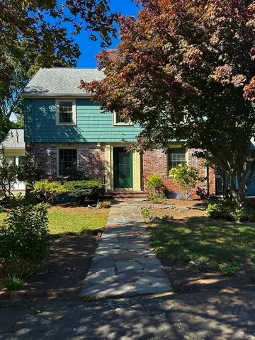 a front view of a house with a garden