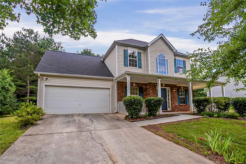 a front view of a house with a garden and plants