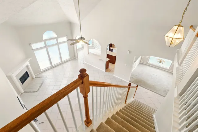 a view of a livingroom with furniture staircase and a fireplace