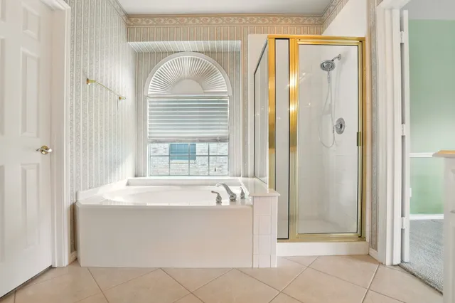 a spacious bathroom with a bathtub and a shower