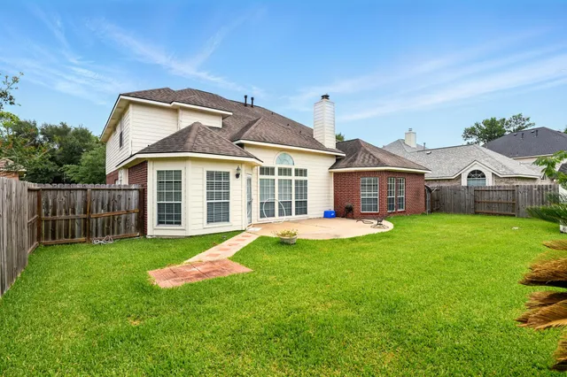 a view of a house with a yard and sitting area