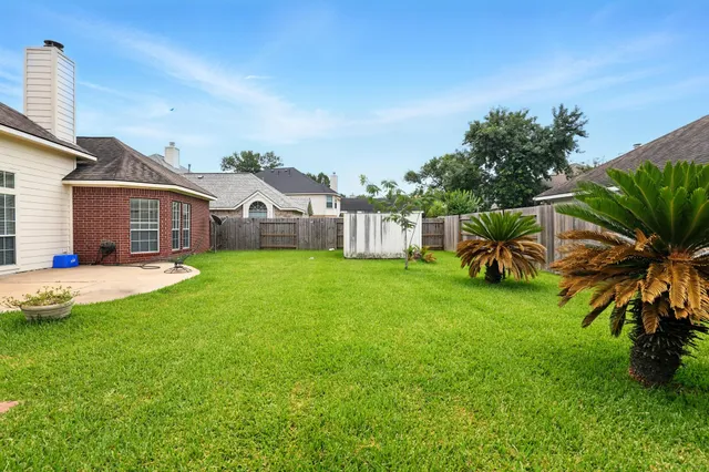 a view of a house with a big yard and potted plants
