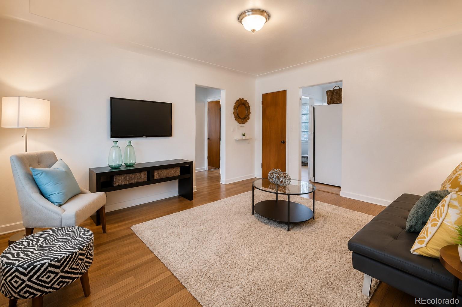 2050 Perry Street Denver, CO 80212 - Photo 3 of 15 a living room with furniture and a flat screen tv