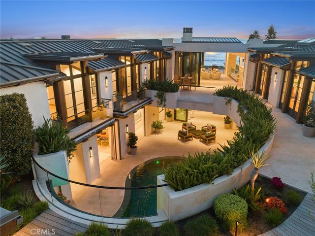 an aerial view of a house with a ocean view