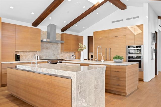 a view of a patio with couches table and chairs and potted plants