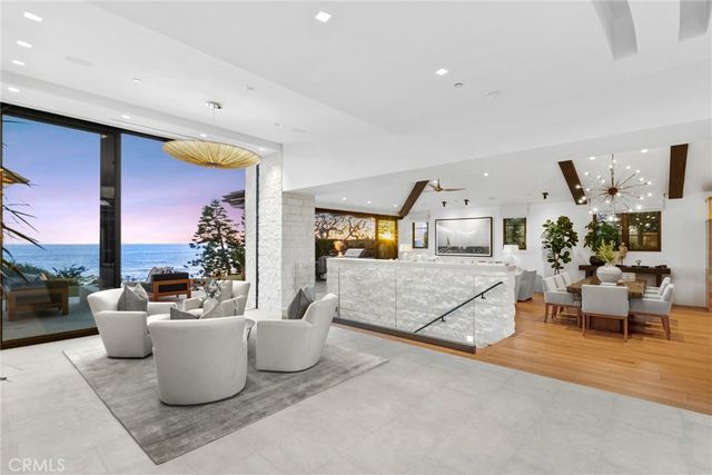 a bedroom with a bed a couch and a flat tv screen