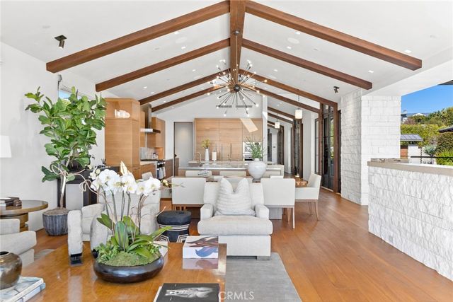 a spacious bedroom with a bed a lamp and a chandelier