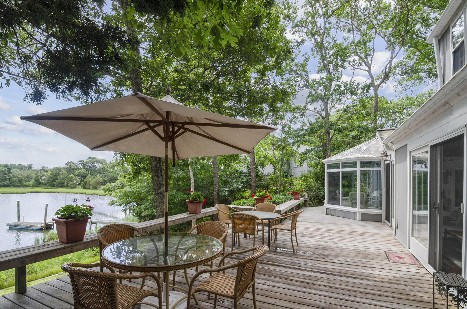 33 Fiddler Crab Lane Mashpee, MA 02649 - Photo 16 of 23 a patio with a table and chairs under an umbrella