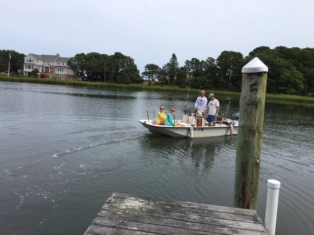 33 Fiddler Crab Lane Mashpee, MA 02649 - Photo 22 of 23 a view of a lake with boats and trees in the background