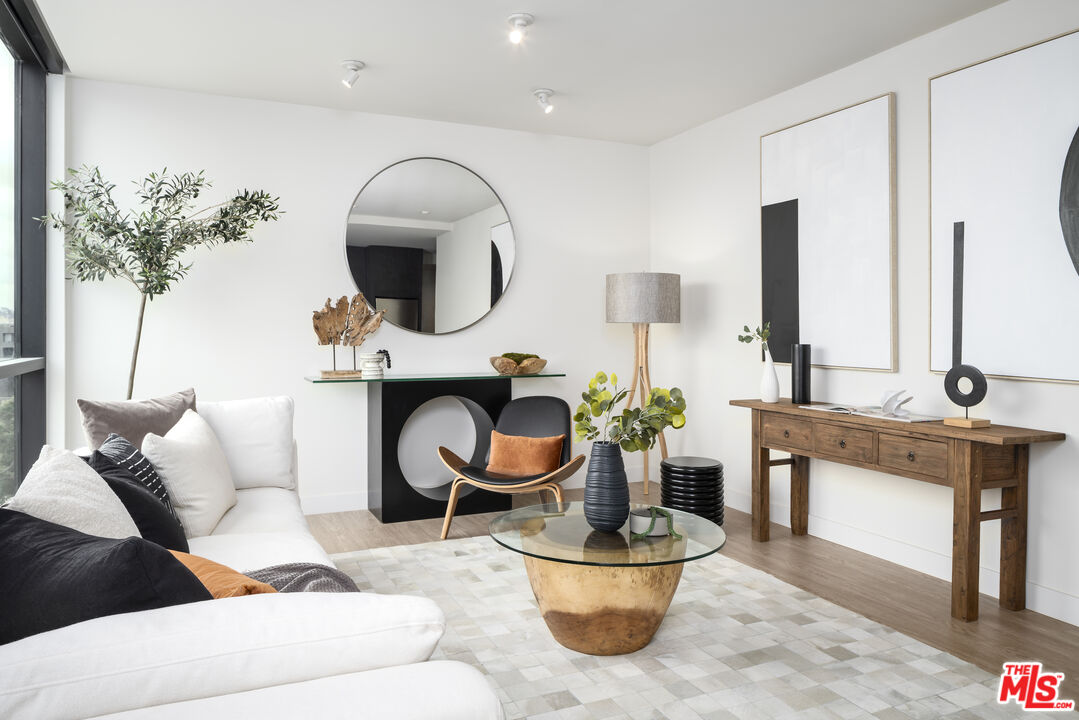 3667 Keystone Avenue, Unit 426 Los Angeles, CA 90034 - Photo 2 of 30 a living room with furniture a potted plant and a fireplace