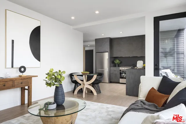 a living room with furniture a fireplace and a potted plant