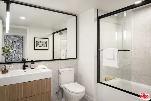 a bathroom with a sink a mirror and a toilet