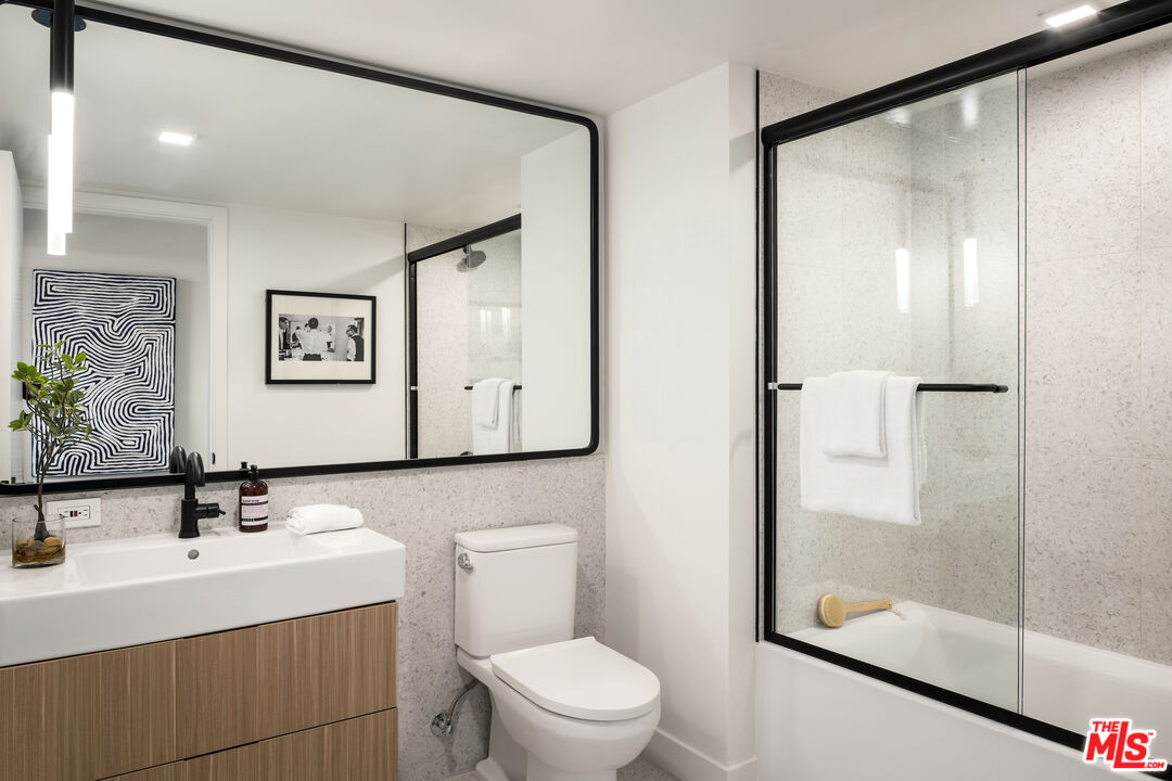 3667 Keystone Avenue, Unit 426 Los Angeles, CA 90034 - Photo 10 of 30 a bathroom with a sink a mirror and a toilet