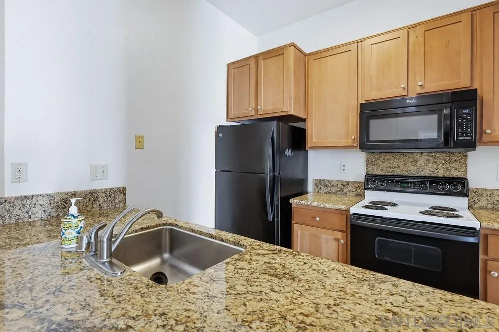 8324 Regents Road, Unit 2E San Diego, CA 92122 - Photo 9 of 31 a kitchen with a refrigerator stove and sink