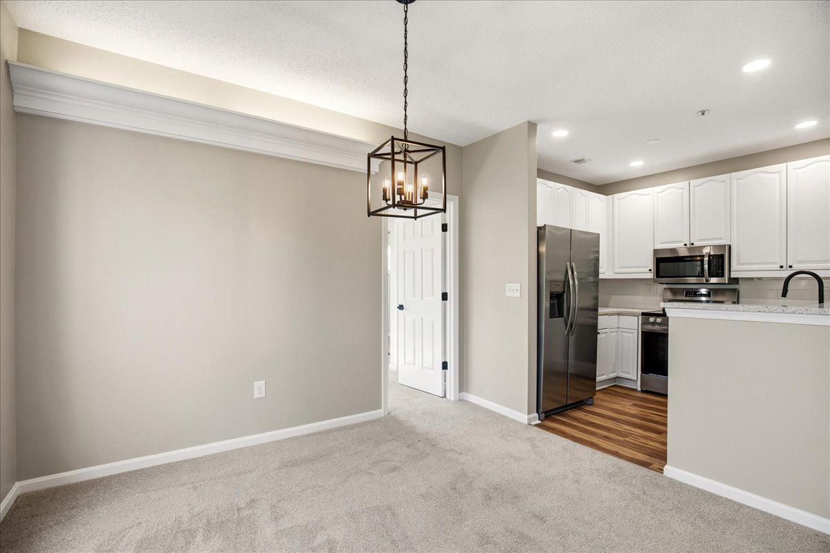 1223 Back Creek Loop, Unit 1223 Solomons, MD 20688 - Photo 15 of 44 a view of a kitchen with refrigerator and windows