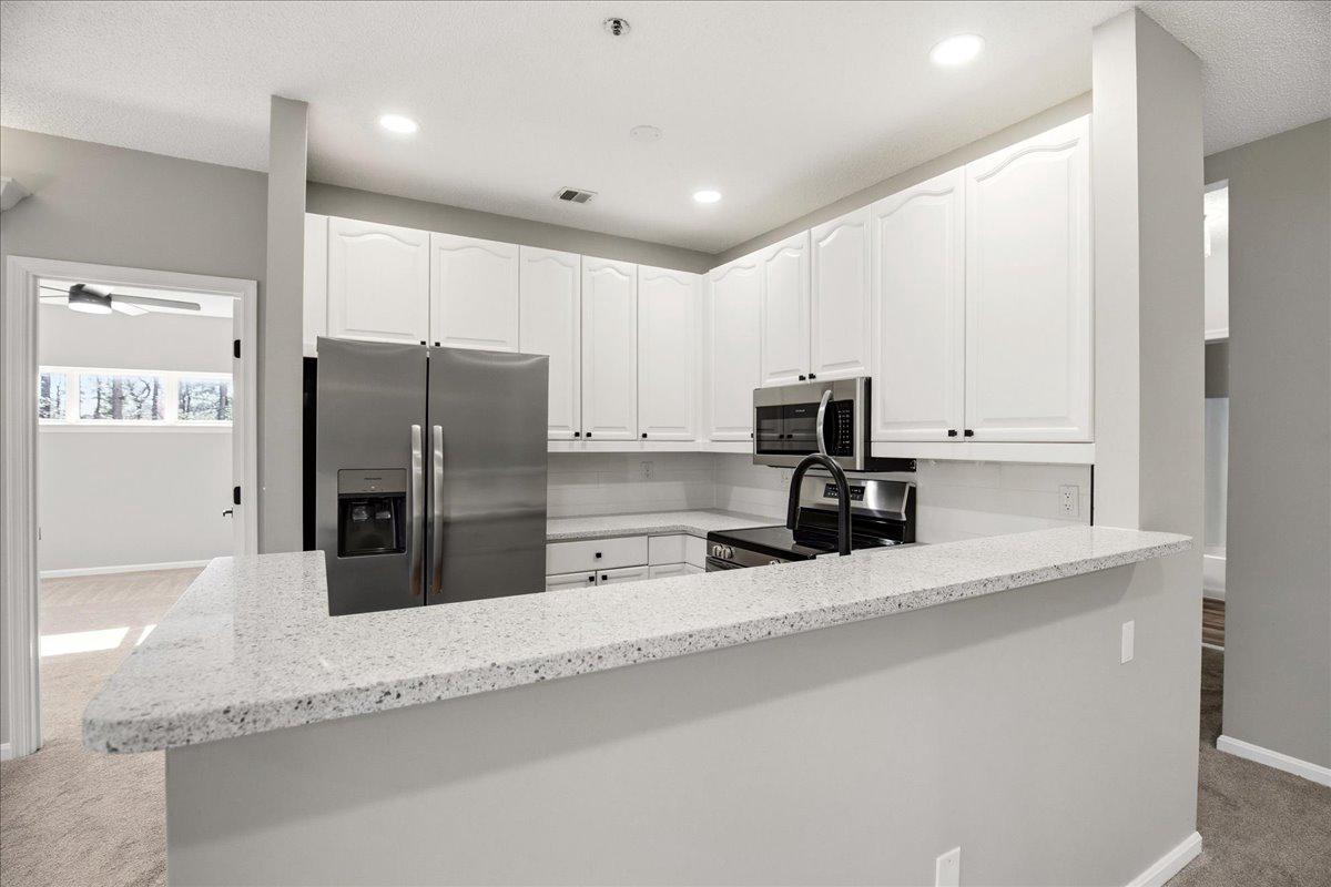 1223 Back Creek Loop, Unit 1223 Solomons, MD 20688 - Photo 17 of 44 a kitchen with stainless steel appliances granite countertop a refrigerator and a sink