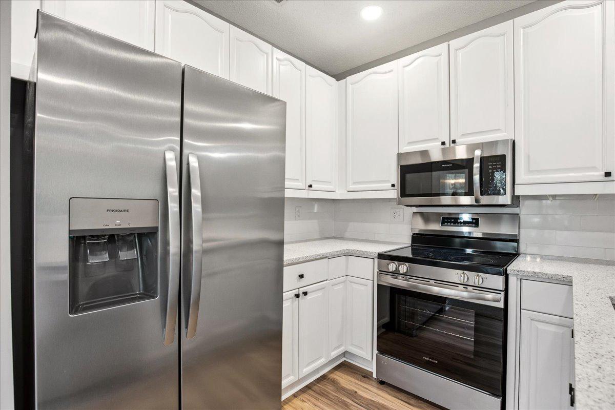 1223 Back Creek Loop, Unit 1223 Solomons, MD 20688 - Photo 18 of 44 a kitchen with cabinets and stainless steel appliances