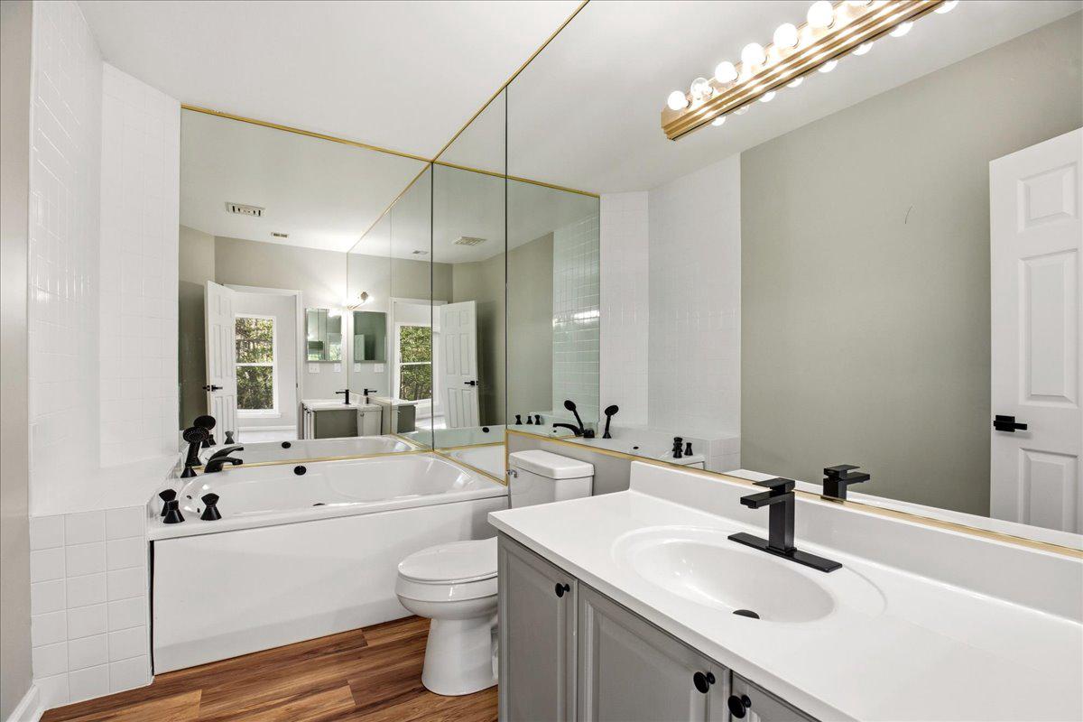 1223 Back Creek Loop, Unit 1223 Solomons, MD 20688 - Photo 23 of 44 a bathroom with a sink a toilet a mirror and shower