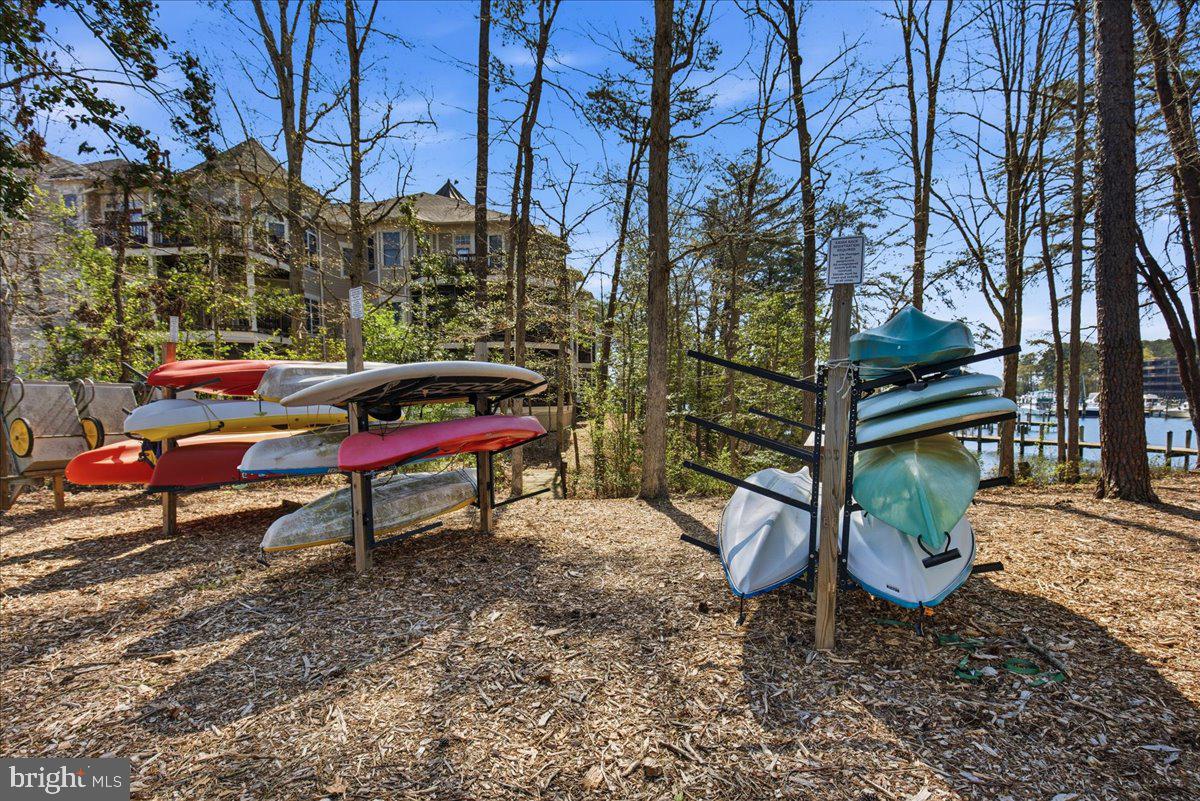 1223 Back Creek Loop, Unit 1223 Solomons, MD 20688 - Photo 34 of 44 a bench is sitting in the middle of a yard