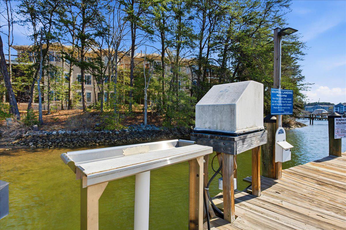 1223 Back Creek Loop, Unit 1223 Solomons, MD 20688 - Photo 37 of 44 a view of a patio with table and chairs a barbeque with wooden floor and fence