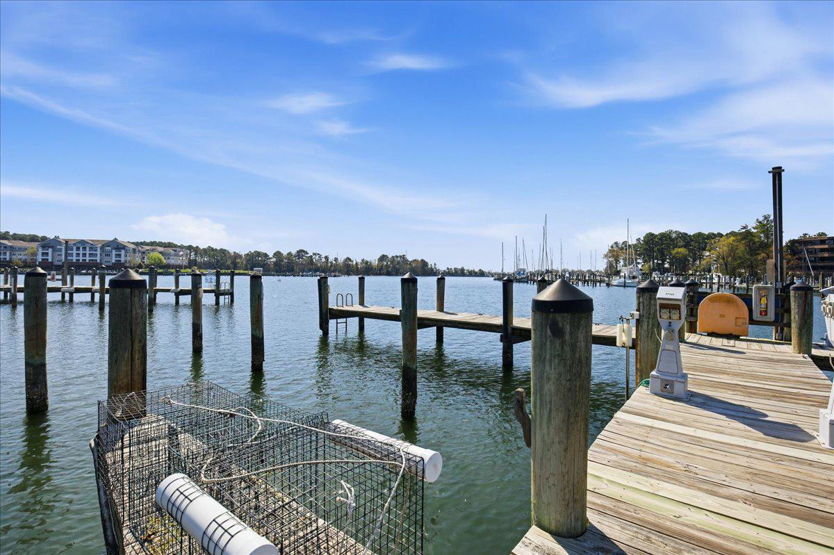 1223 Back Creek Loop, Unit 1223 Solomons, MD 20688 - Photo 38 of 44 a roof deck with a table and chairs