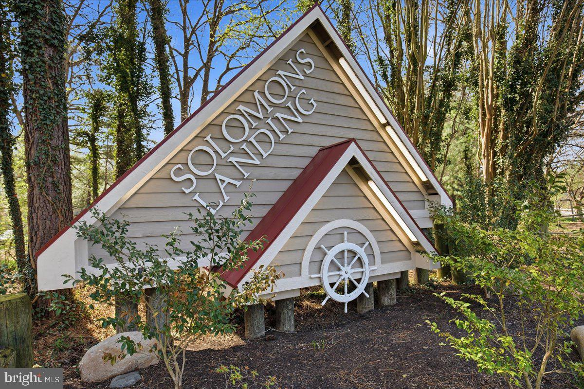 1223 Back Creek Loop, Unit 1223 Solomons, MD 20688 - Photo 3 of 44 a view of a house with a yard and hanging chair