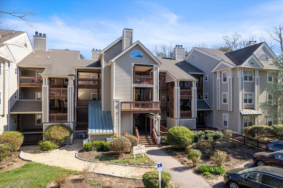 1223 Back Creek Loop, Unit 1223 Solomons, MD 20688 - Photo 7 of 44 a front view of a house with a yard