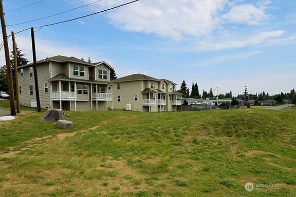 2905 11th Street, Unit AD Everett, WA 98201 - Photo 4 of 17 a front view of a house with a yard