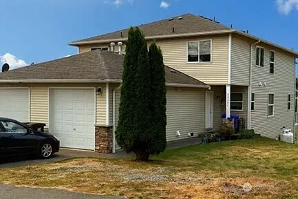 a front view of a house with a yard
