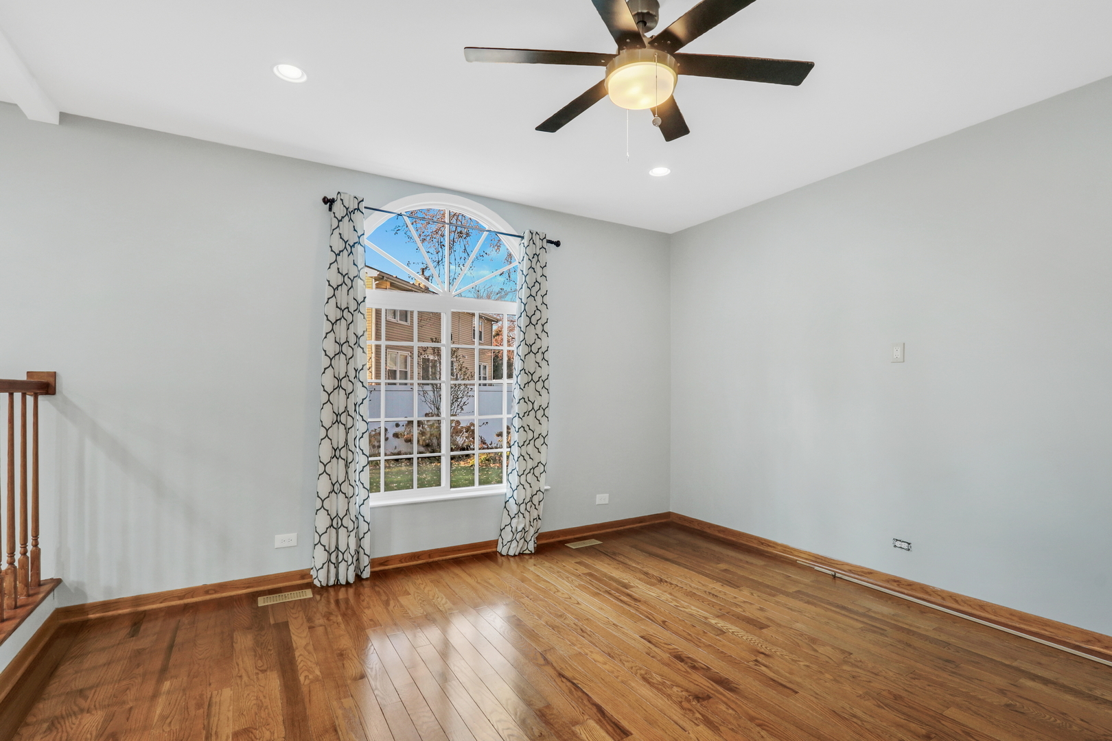 5315 Cypress Circle Gurnee, IL 60031 - Photo 12 of 31 an empty room with wooden floor fan and windows
