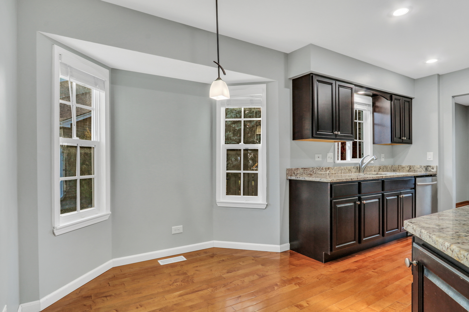 5315 Cypress Circle Gurnee, IL 60031 - Photo 3 of 31 a kitchen with kitchen island granite countertop a stove and a sink