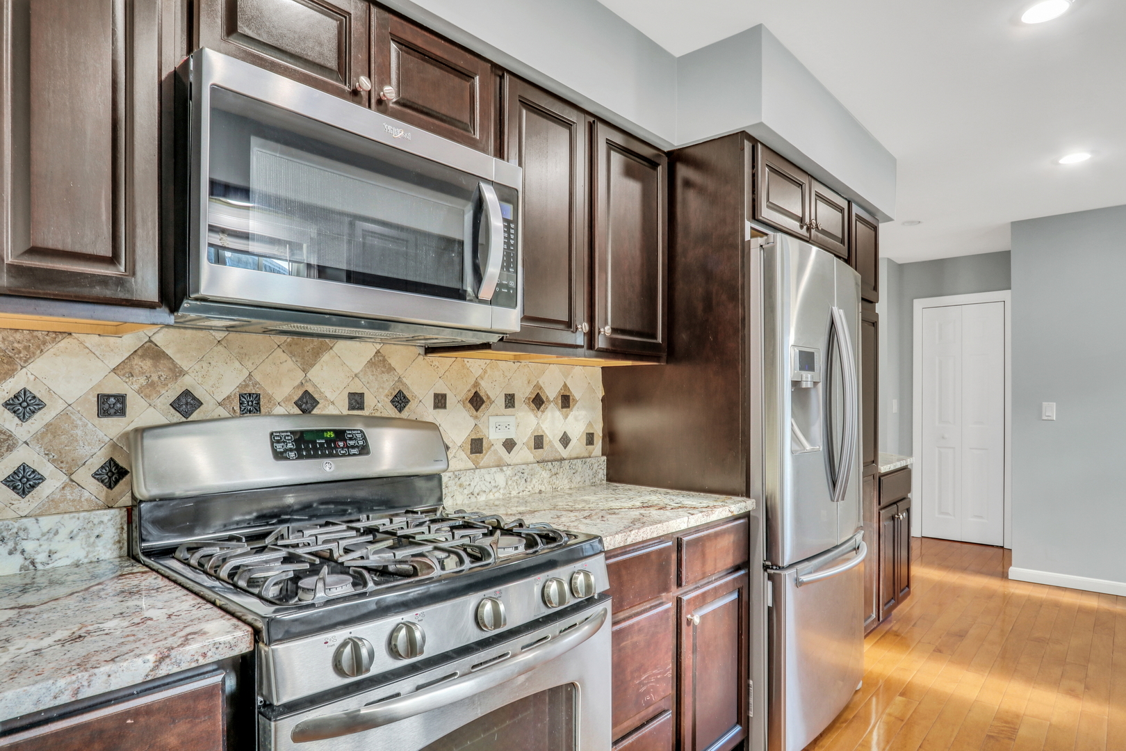 5315 Cypress Circle Gurnee, IL 60031 - Photo 7 of 31 a kitchen with stainless steel appliances granite countertop a stove and a refrigerator