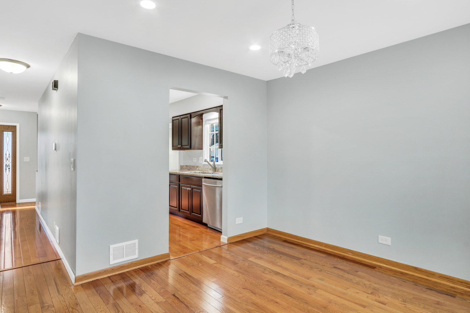 5315 Cypress Circle Gurnee, IL 60031 - Photo 9 of 31 a view of a kitchen with wooden floor and a hallway